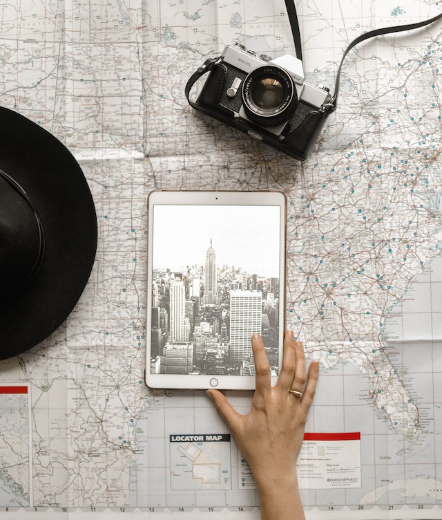 pexelselementdigital1051077 | Path Social Person Touching Silver Ipad on World Map Chart Beside Black Hat