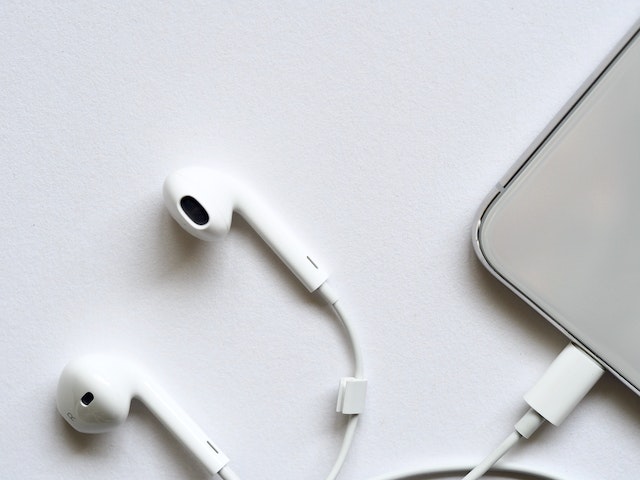Apple earphones connected to phone