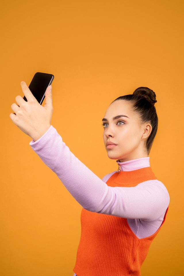 Woman taking a video selfie.