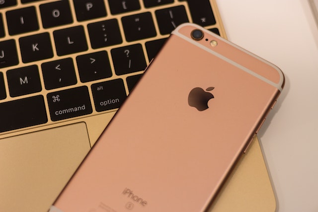 Rose gold iPhone on Macbook.