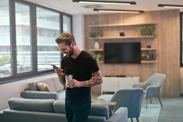 Man catching a break at work by watching some funny Reels.