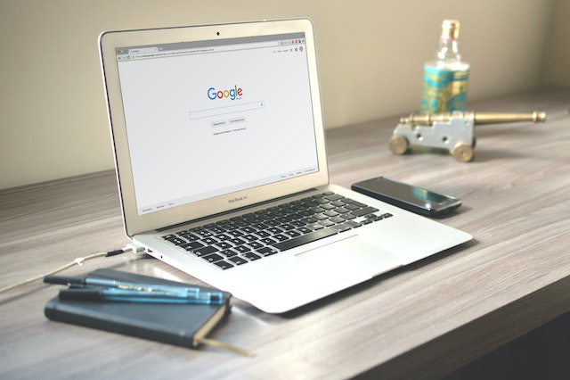 A laptop displaying the Google search screen that signifies searching for an online Instagram downloader.