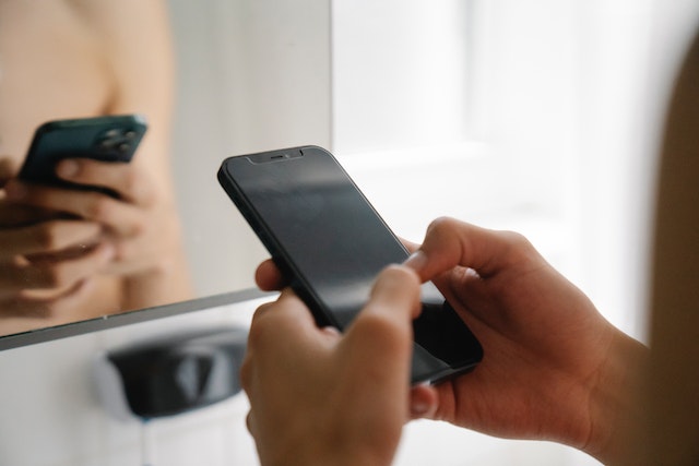 pexels-eren-li-7241330 | Path Social Unseen person using an all-black smartphone.