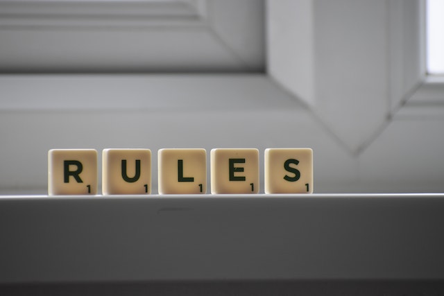 Cubes with RULES inscription on a windowsill in a building.