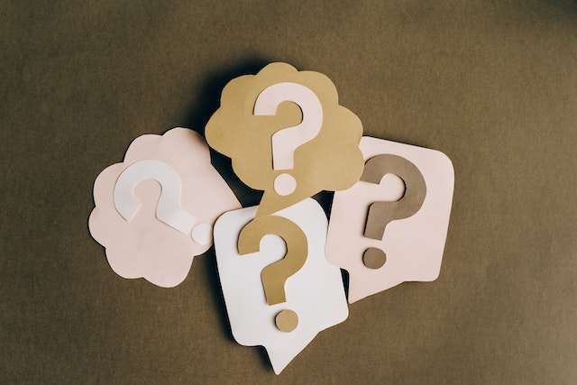 pexels-leeloo-thefirst-5428836 | Path Social Brown, pink and white paper cut-outs of question marks with text bubbles.