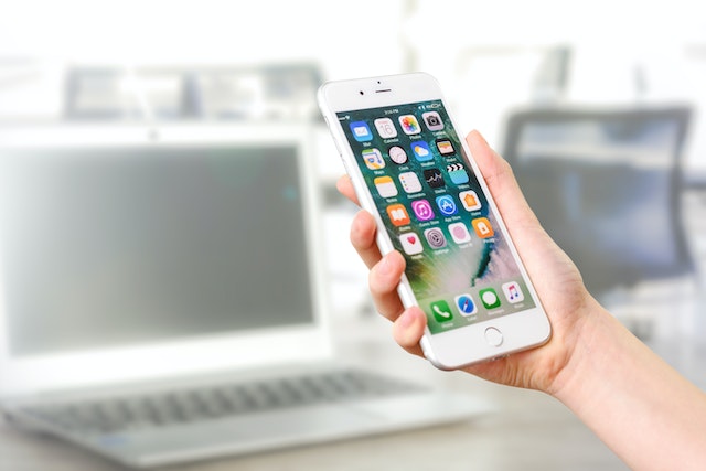 pexels-photomix-company-887751 | Path Social Hand holding silver IPhone.