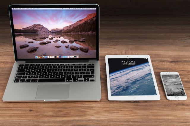 A laptop, Ipad and Iphone on the table