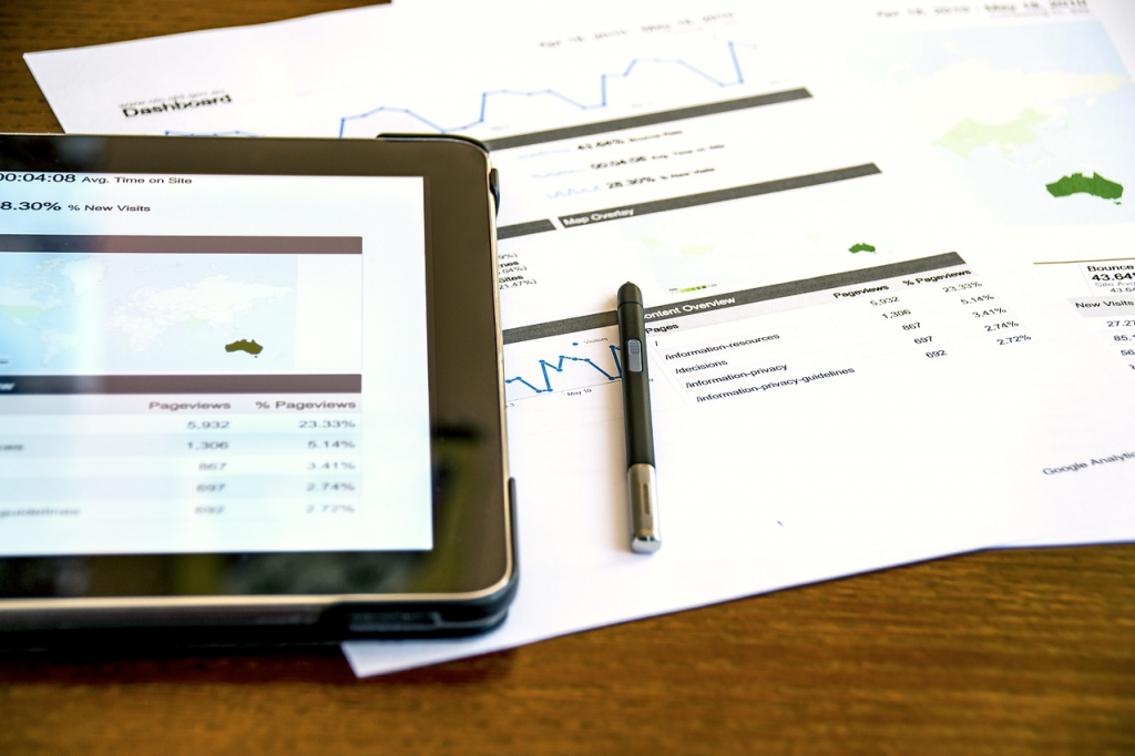 Analytics displayed on a tablet and sheets of paper