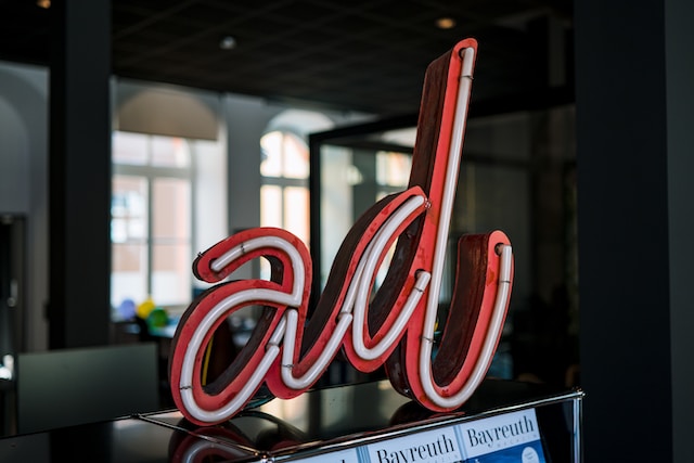 Neon sign with the word “ad” sitting on a counter top.