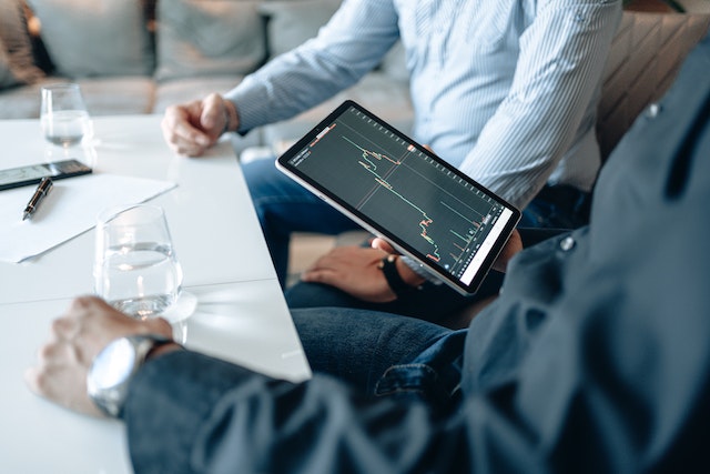 Man looking at a graph on iPad.