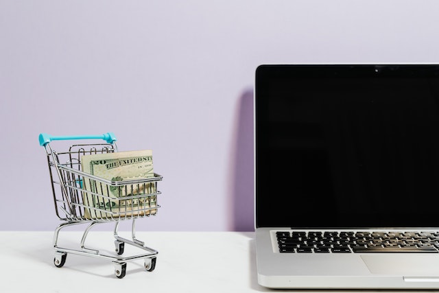 pexels-karolina-grabowska-5632397 | Path Social Laptop e carrello della spesa con banconote da un dollaro