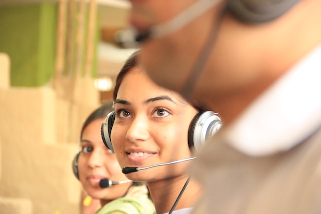 A Customer care representative listening patiently to a user’s complaints. 