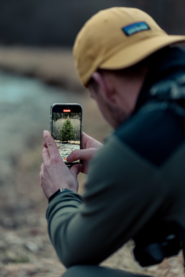 A man filming a video to update his followers on his hike.