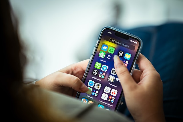 A user ready to open the Threads app on her smartphone.