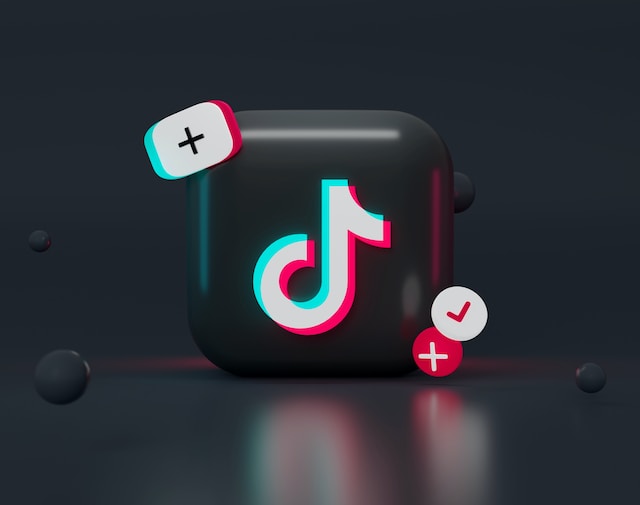 Tiktok app icon surrounded by graphics. 
