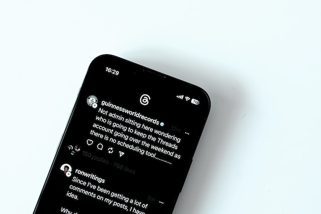 The threads app displays user posts and interactions.