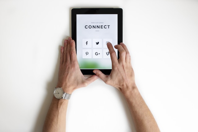 A close view of a person clicking the Instagram app icon on a black iPad.