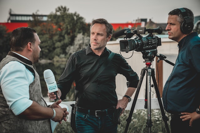 Man holding a mic and taking an interview