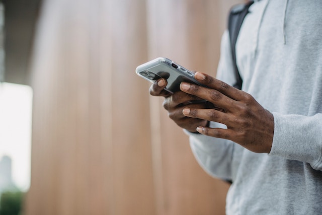 pexels-william-fortunato-6140934 | Path Social An influencer scrolling through his Instagram chat list on his smartphone.
