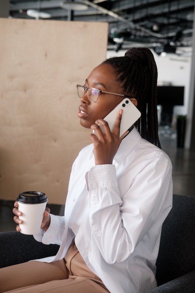 A woman has a phone call through her DMs.