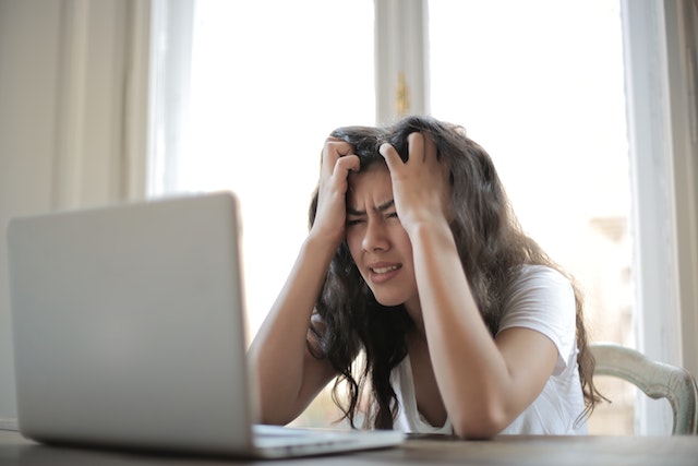 Woman frustrated while watching her Instagram follower count drop.