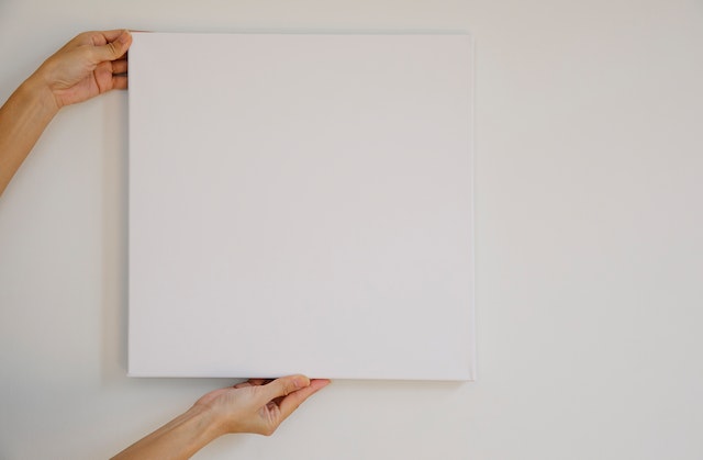 pexels-angela-roma-7319274 | Path Social Unseen person holding a blank canvas up to a wall.
