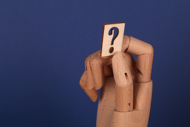 pexels-ann-h-10981241 | Path Social Una mano sosteniendo un signo de interrogación que representa si comprar seguidores falsos de Instagram o no.