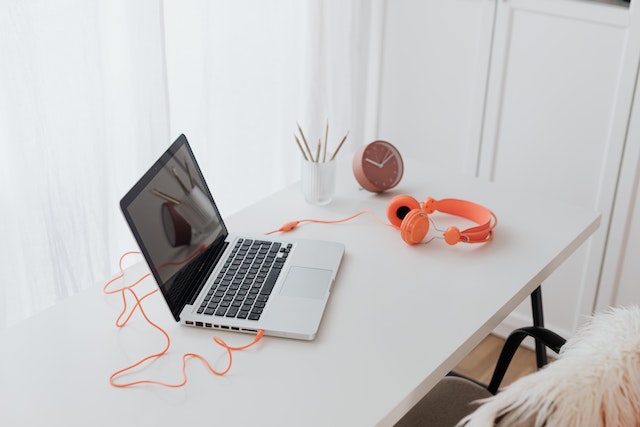 Headphones connected to a computer representing accessibility for vision-impaired genuine IG followers.