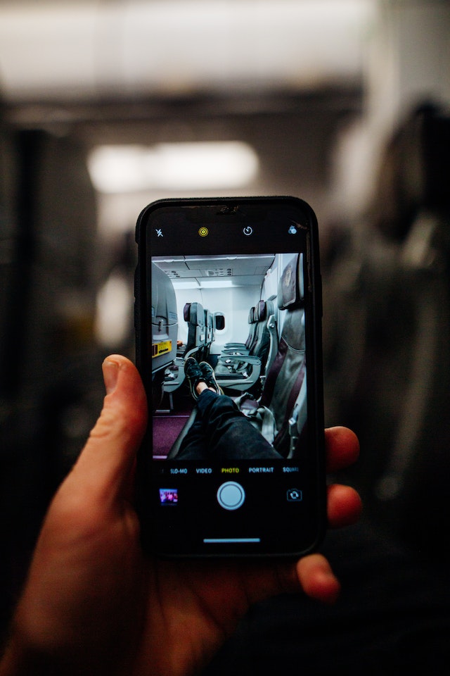 a hand holding a phone with a picture of a person's feet