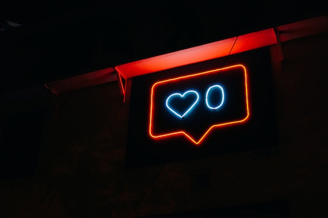A neon light version of the Instagram likes logo representing gaining Instagram followers free.