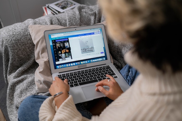 A woman using Canva on laptop
