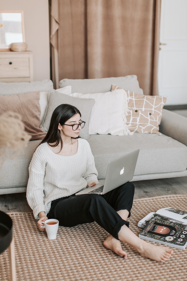 A woman organizes her notes on her laptop for her Instagram Live.