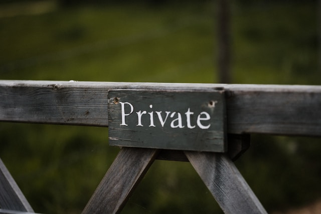 A grey wooden signage that says "Private".