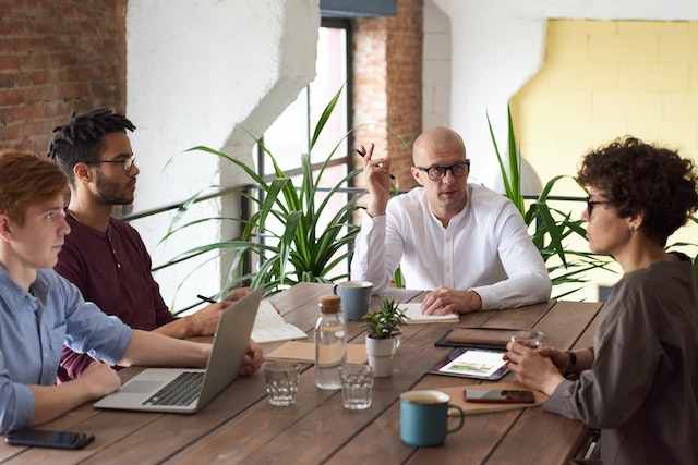 Social media managers for a brand get together to discuss goals.