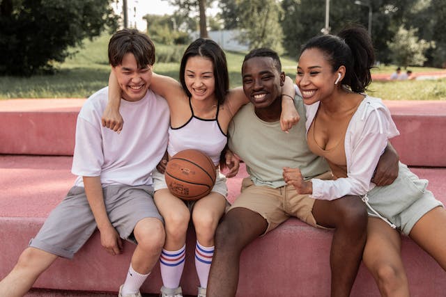 A group of close friends taking a photo after playing sports.