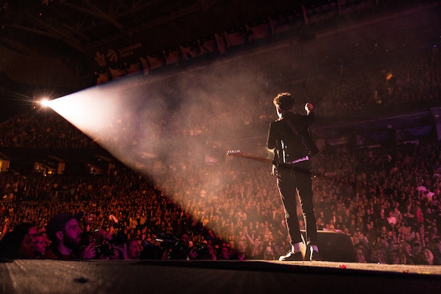 Famous person on stage in front of his many fans.