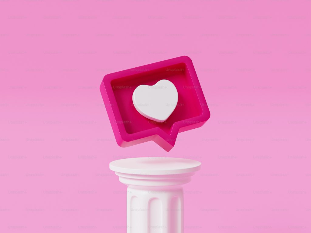Um símbolo Instagram 'Gosto' branco dentro de um símbolo de caixa de comentários cor-de-rosa.