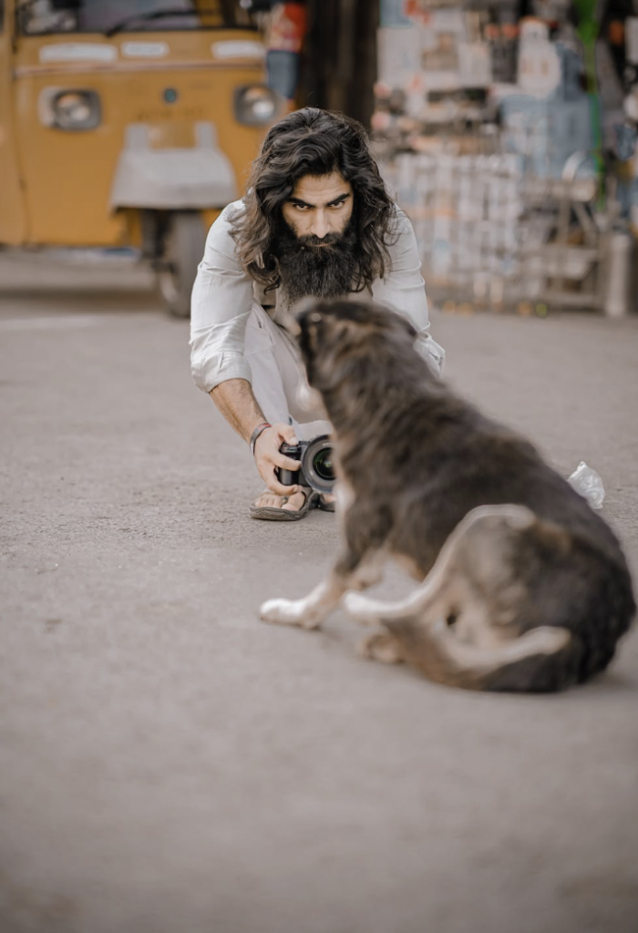 A content creator takes a photo of their dog on the ground.