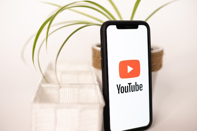 A phone displaying YouTube on its screen. 