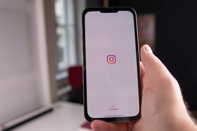 A photo of a mobile phone screen displaying the Instagram logo.