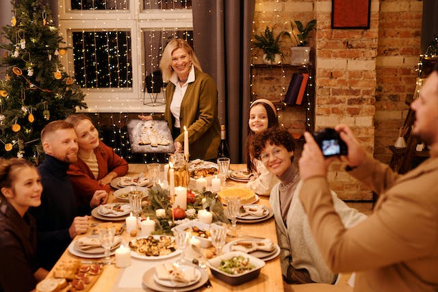 A family gathering to take their annual Christmas photo after dinner.