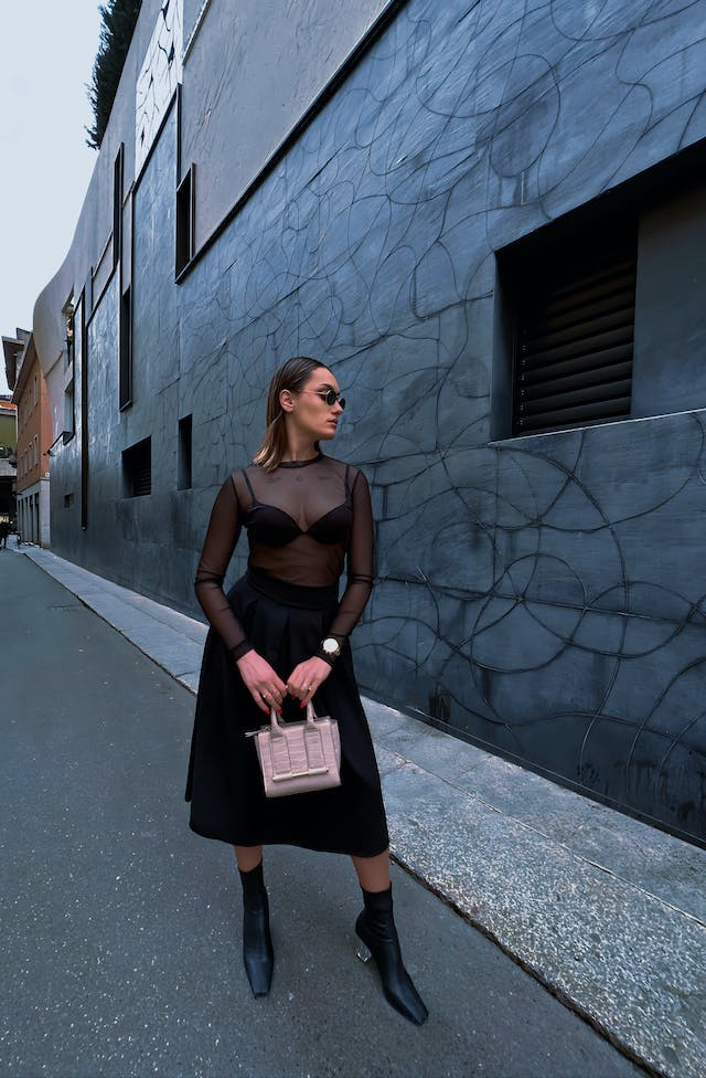 An Instagram model takes a photo on the side of the road.