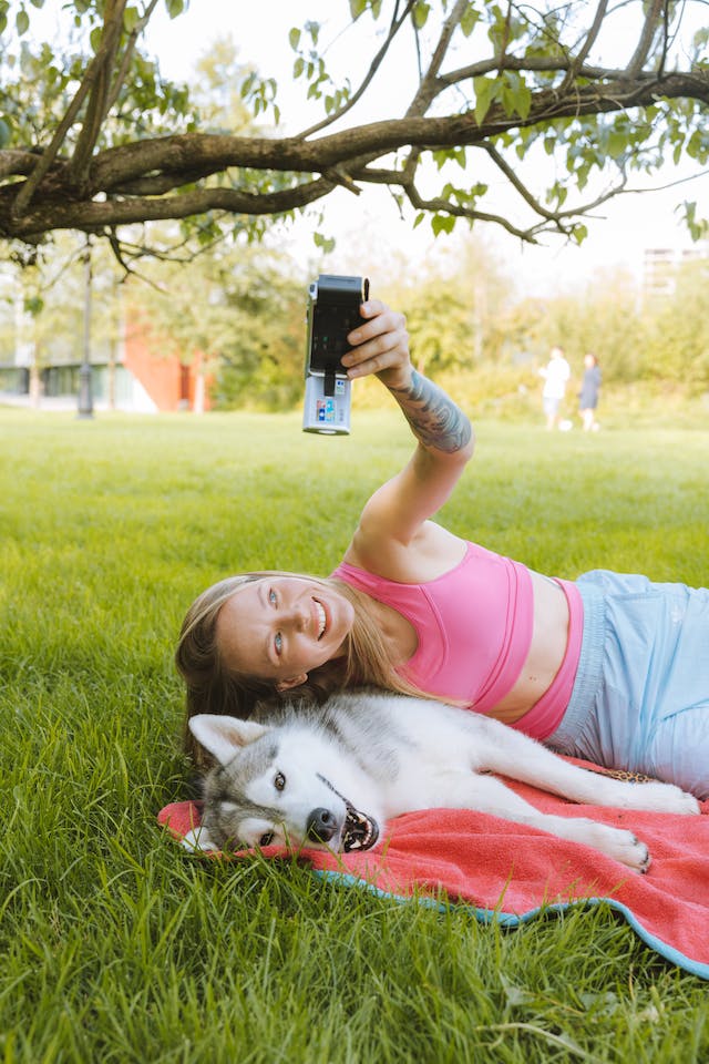 A woman takes a selfie with her Husky.