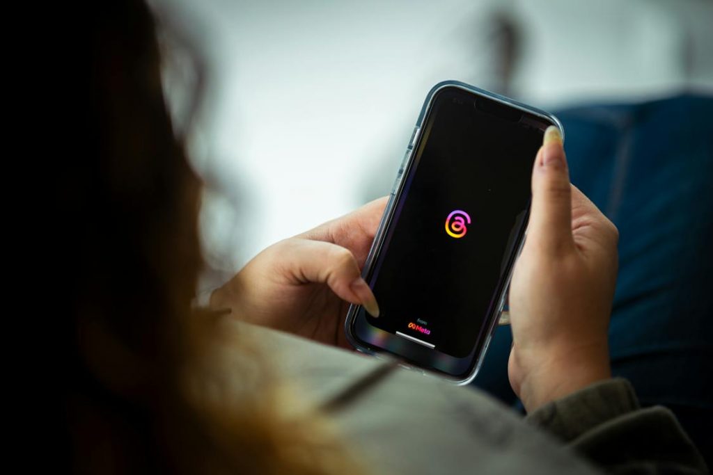 A woman is opening the Instagram application on a smartphone.