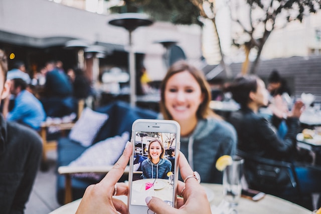 A girl recording an influencer's video for her account. 