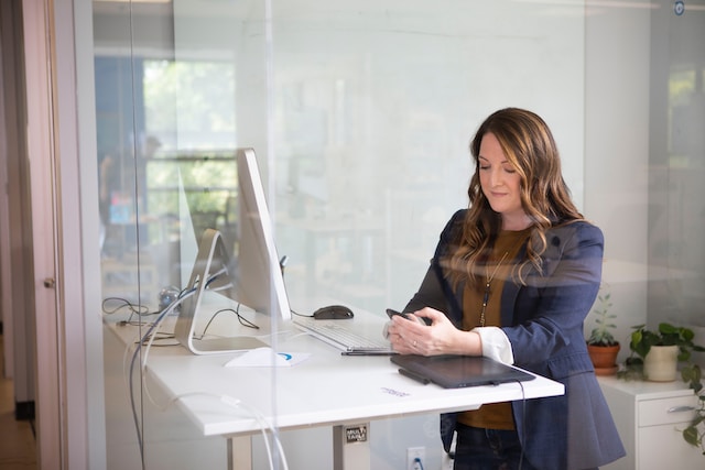 A woman in an office using her phone to check for Instagram username availability.