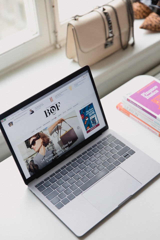 A woman uses her laptop to get her business website ready for an Instagram account.