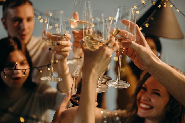 A group of friends toasting their drinks on New Year’s Eve.