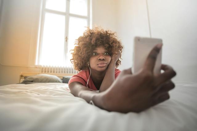 An influencer is taking a selfie for her IG account. 