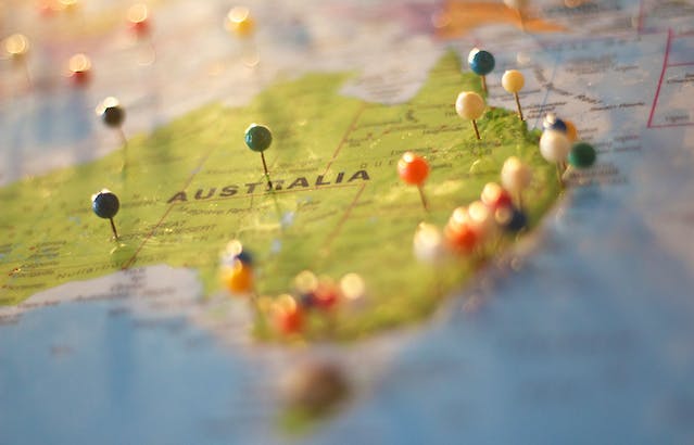 A world map with pins on multiple cities in Australia